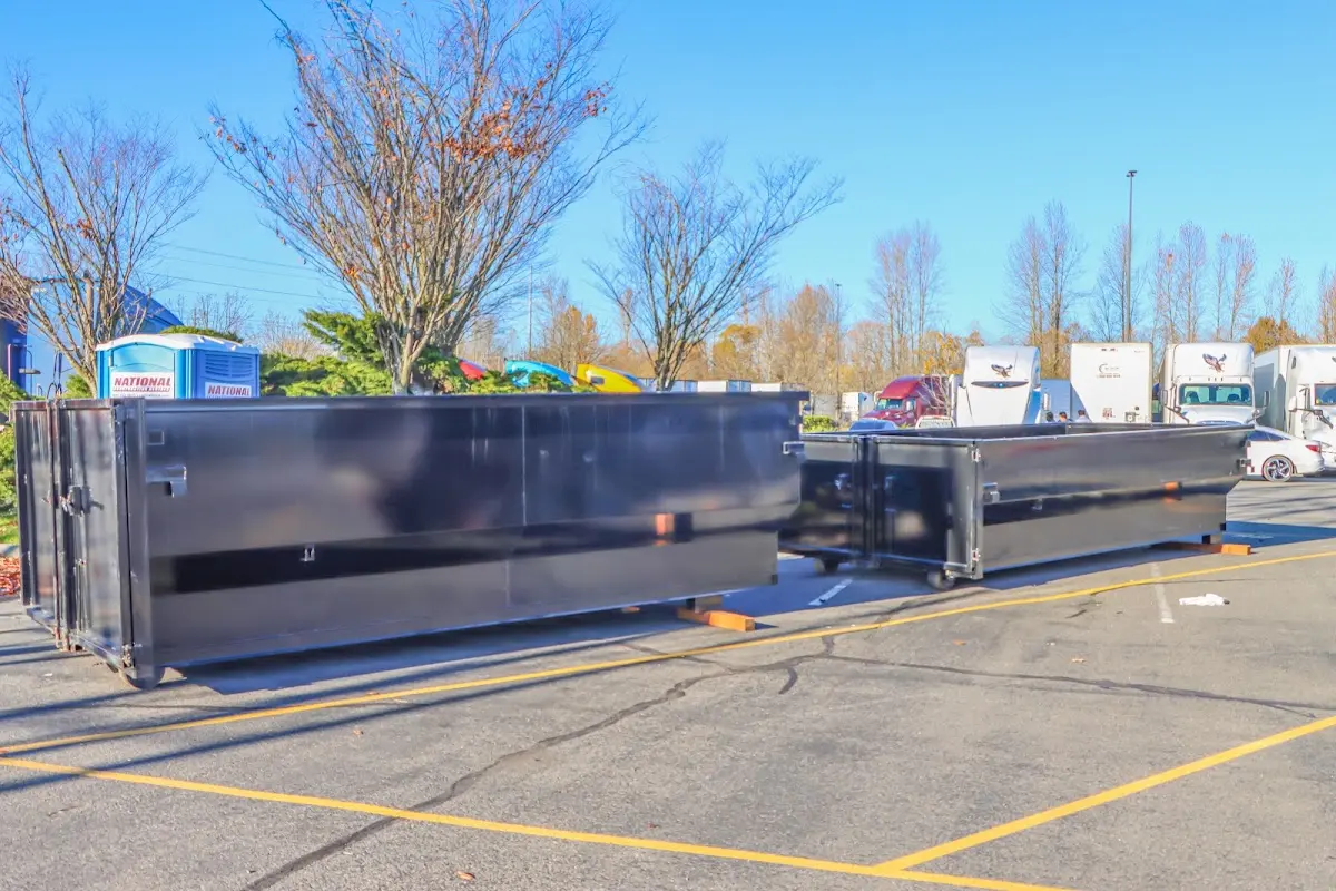 Professional dumpster rental service with roll-off container on residential driveway in Austintown